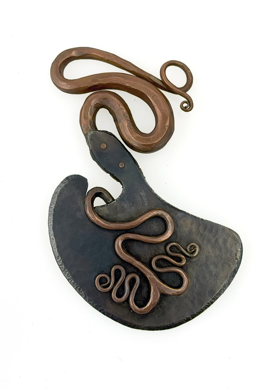 Forged and chased snake herb chopper
